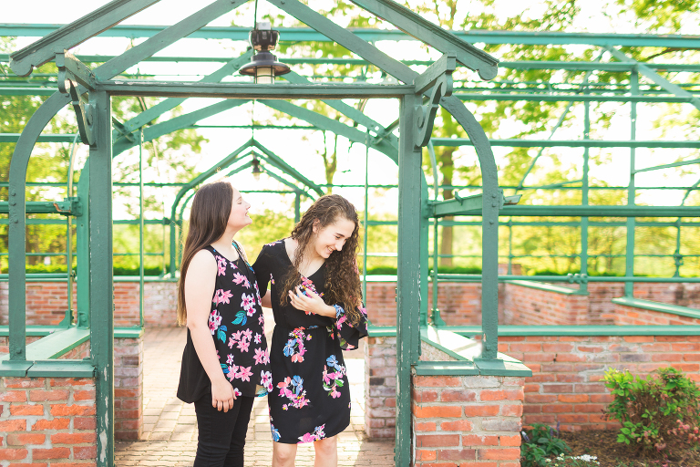 Sisters laughing at each other | St. Louis Family Photographer