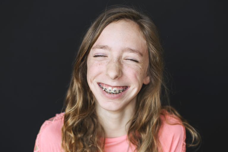 Young lady laughing for school photo | St. Louis School Photos