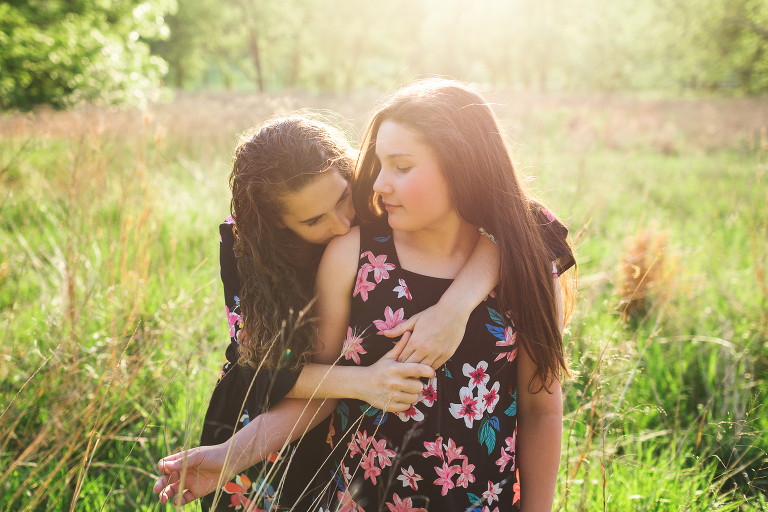 Two sisters showing affection | St. Louis Family Photographer