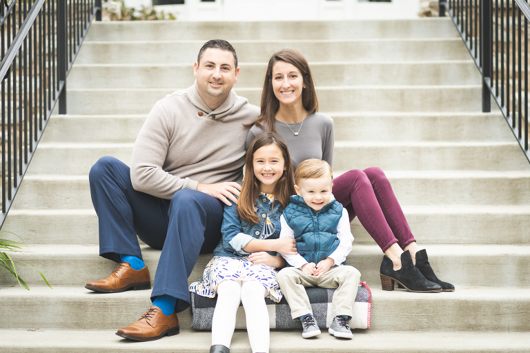 Family of four sitting on steps at Oak Knoll Park | St. Louis Photography