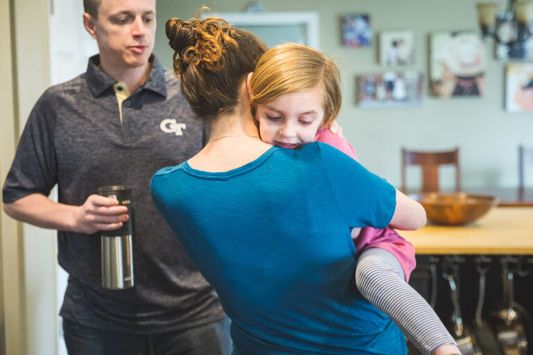 Mom hugging daughter in kitchen | St. Louis Photography