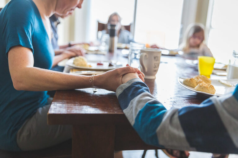 Mom and son holding hands while praying | St. Louis Photography