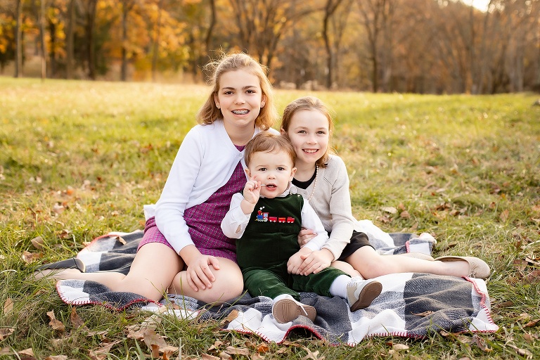 Little brother sucking on a lollipop during family photos | STL Photos