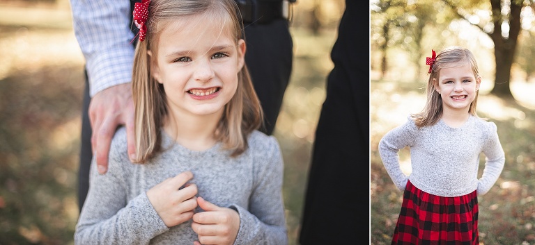 Young girl wearing a buffalo check dress smiling at camera | St. Louis Family Photographer