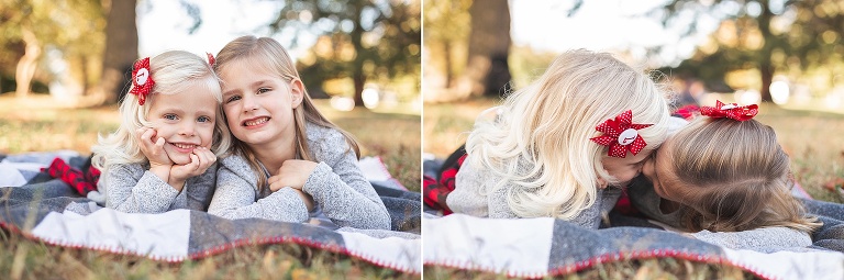 Sisters laying on their bellies on blanket in park in fall | STL photography
