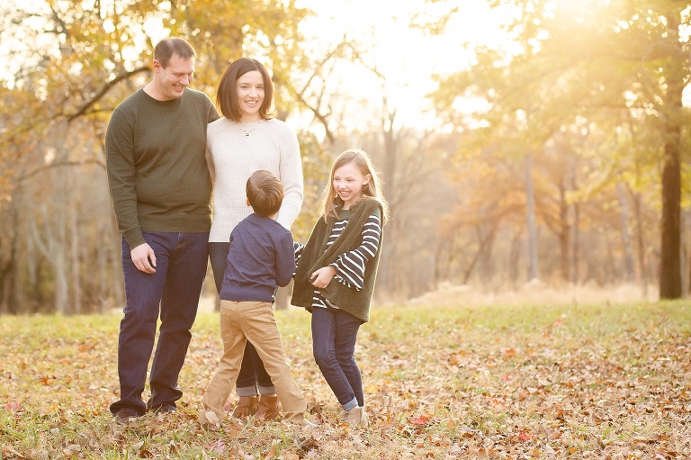 Sun filled photo of family of four having fun in park | KGriggs Photography