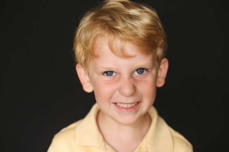 School photo of young boy making a silly face | St. Louis School Photographer