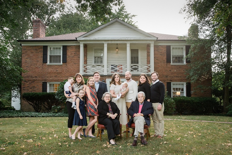 Entire family taking a photo in front of their family home | St. Louis Photographer