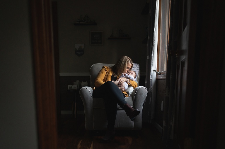 Mom and baby sitting in chair in nursery | KGriggs Photography