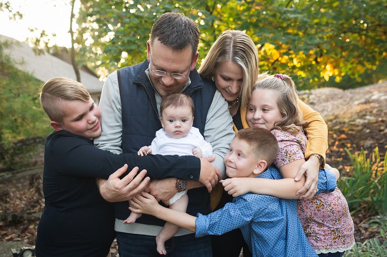 Sweet family of six snuggling in their front yard on fall evening | KGriggs Photography
