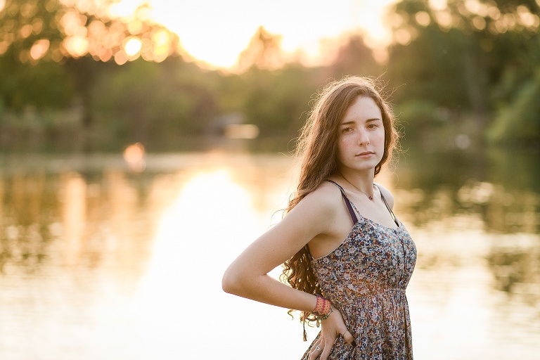 High school senior standing with sun behind her | KGriggs Photography