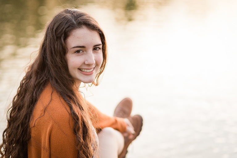 High school senior sitting near water at Forest Park | St. Louis Senior Photography